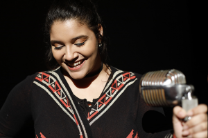 Delaney Barker laughs at stand-up microphone