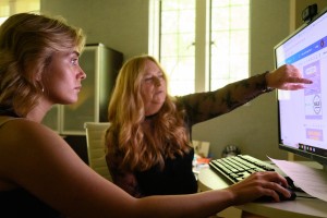 Leah Fanello works at the computer with Tabitha Payne, associate professor of psychology
