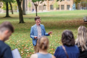 Adam Serfass leading a tour of Kenyon's Latin and Greek inscriptions