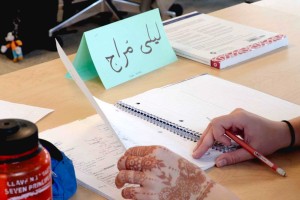 A photo showing an Arabic name plate and notebook