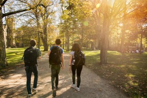 Three students walking down Middle Path