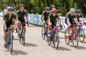 Associate Professor of Biology and Environmental Studies Iris Levin (center in red helmet) and Assistant Professor of Biology Toshi Tsunekage (second from right) finish a 100-mile route for Pelotonia in 2022 in Gambier. (Courtesy of Iris Levin)