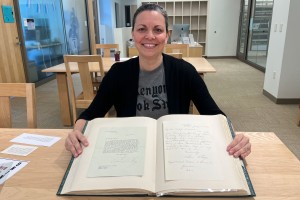 Elizabeth Williams-Clymer with an autograph book that includes signatures from nearly all U.S. presidents.