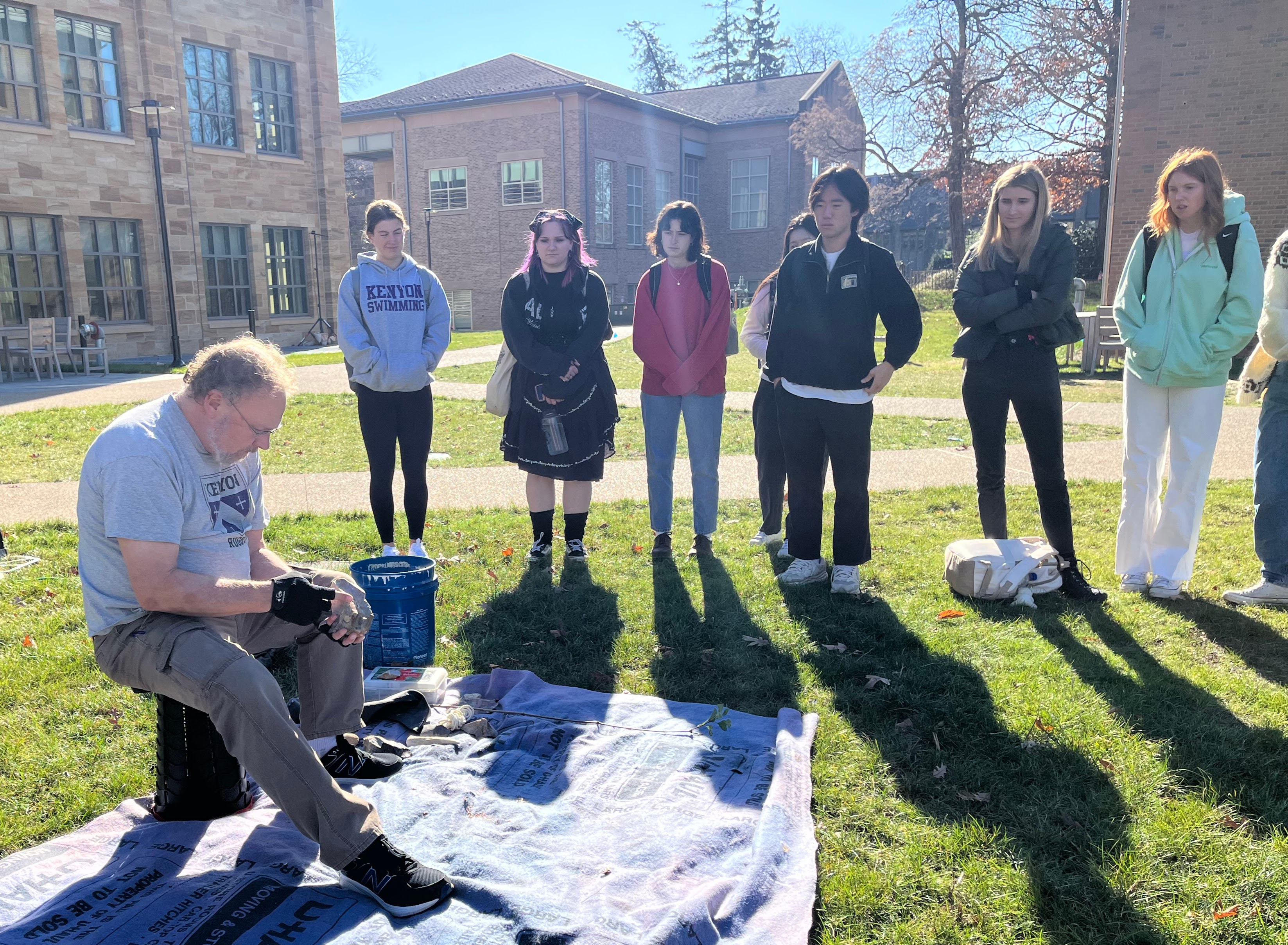 Bruce Hardy demonstrates flintknapping to students in the fall.