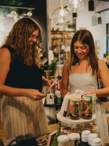 Alexandra Hofacre ’27, left, and Catelin Bromfield ’26, taking part in a photo shoot for a client during their time as interns for Milestone Marketing in Columbus this past summer. (Courtesy of Kristen Orlando-Ricordati ’05)