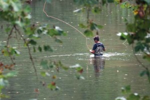 Child fishing in a river