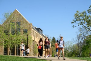 Students strolling and chatting on the path in front of Chalmers Library.
