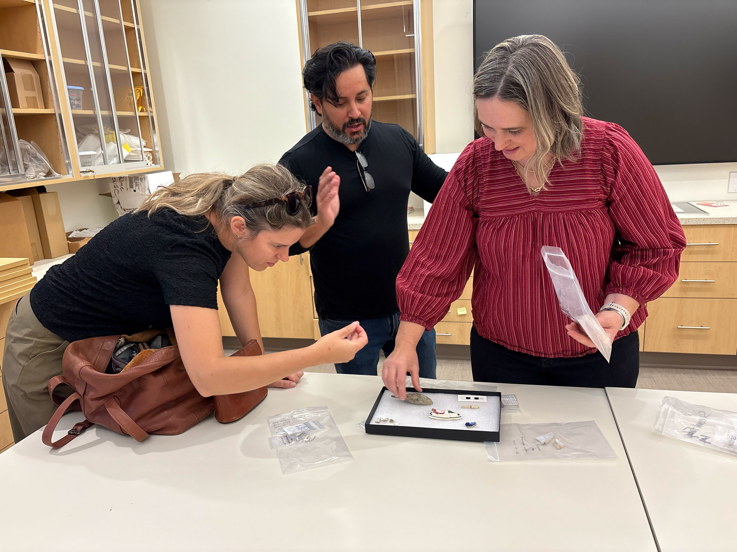 Professors look at artifacts