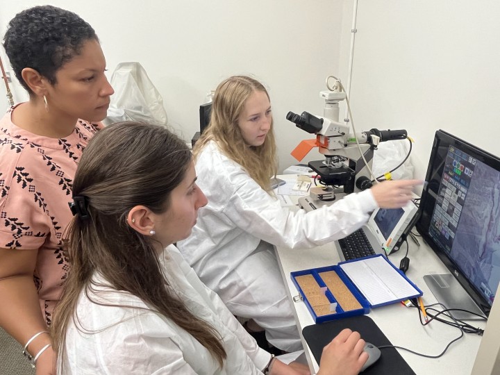 Summer Science Scholar Sophia Knaysi ’24, right, and Cascade Science Scholar Paula Soric '25 examine mouse placenta using a microscope as they study the effects of maternal, prenatal stress on glycogen storage and production. Their mentor for the project is Arianna Smith, assistant professor of biology and the Harvey F. Lodish Faculty Development Professor in the Natural Sciences. Photo by Ryan E. Smith.