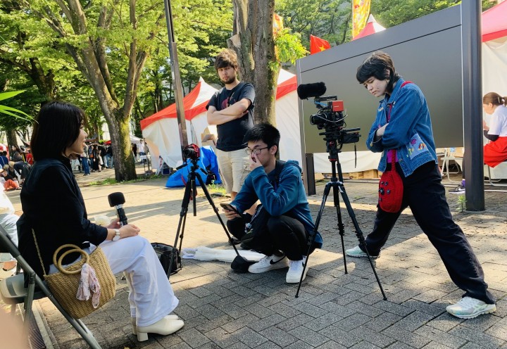 Mia Tsuchida '25, right, interviewing labor migrants in Japan this summer with fellow students, including Long Tran '26, center. Tsuchida is editing that footage as part of a Summer Scholars research project involving Sam Pack, professor of anthropology. Photo by Sam Pack.